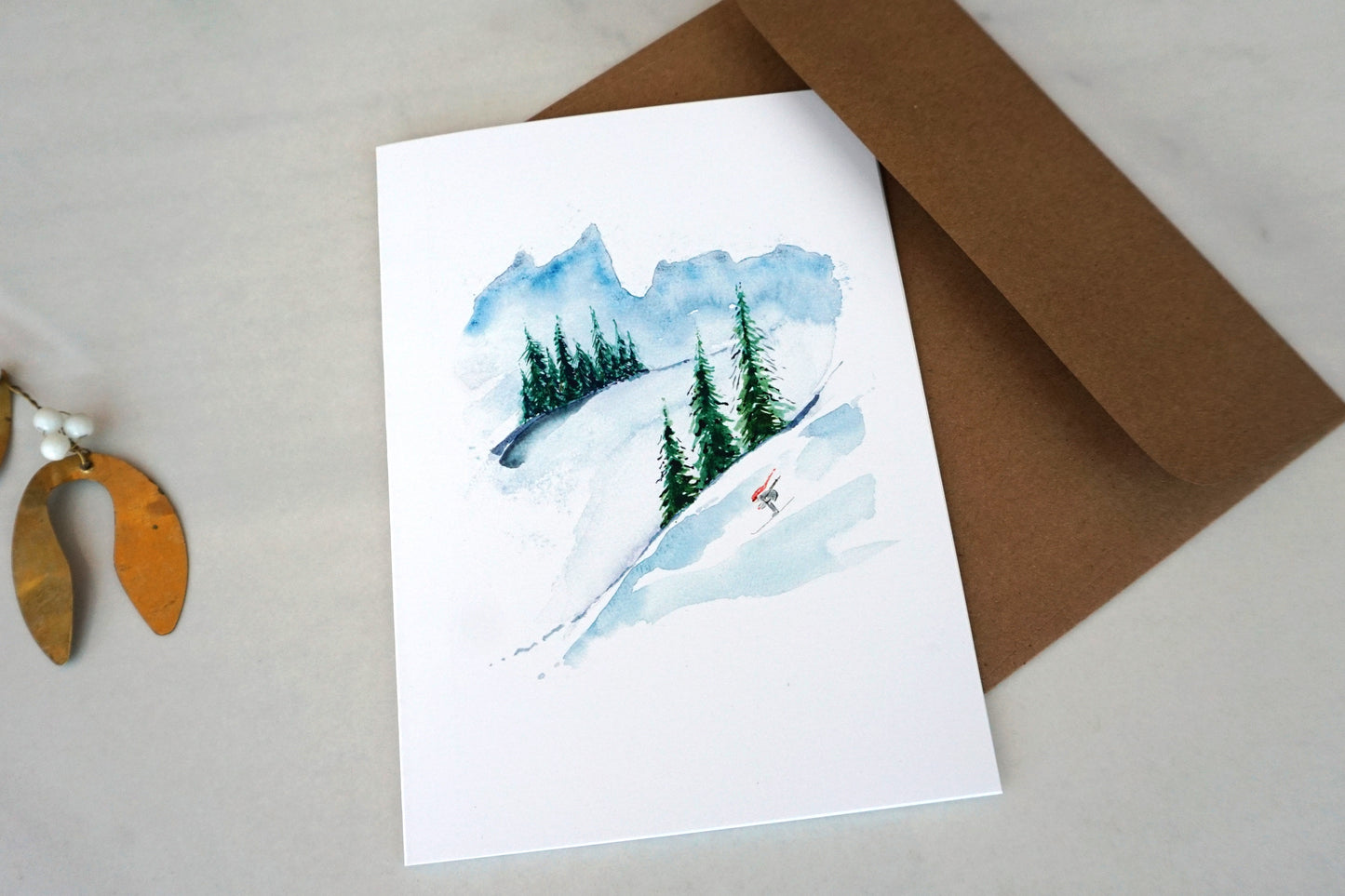 Mountain scene with downhill skier, blank Christmas card